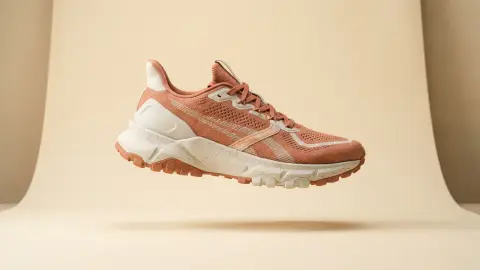 Reference: terracotta trail runner on a sand backdrop